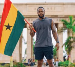 Sam WIlliams with the Ghana flag at the Black Star Square, Accra